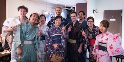 Group wearing yukata poses indoors.