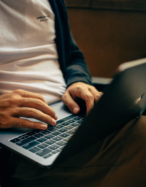 Person typing on a laptop computer's keyboard.