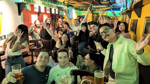 Large group celebrating in a pub.